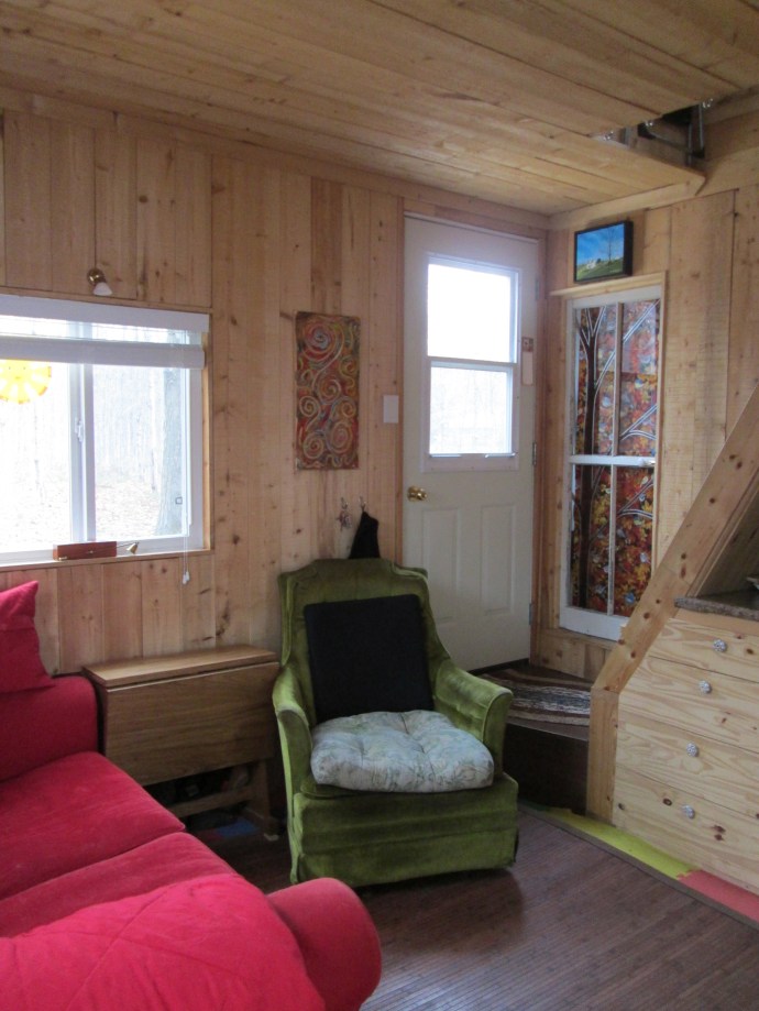 This green chair is where Hj likes to sit.  I would like to pitch this chair because he love to tilt back in it.  This blocks the way to the upstairs, the entry, and the bathroom.  A tilting chair (recovered from the road side) is not the best solution for a tiny house, in my opinion.  