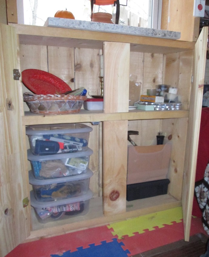 Relocated closed cupboard and new plastic tool bins